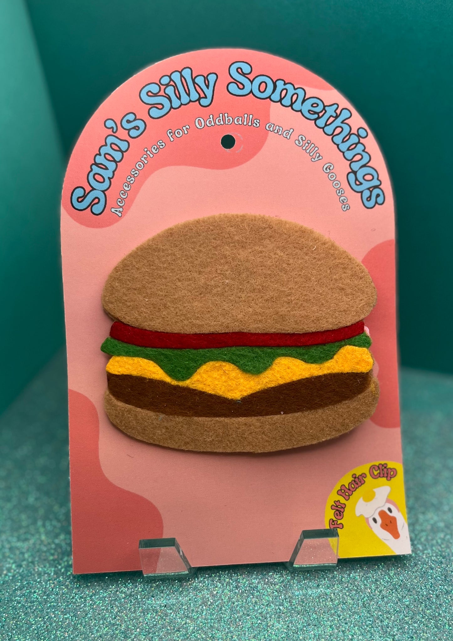 Felt burger clip on a pink packaging with 'Sam's Silly Somethings' branding.