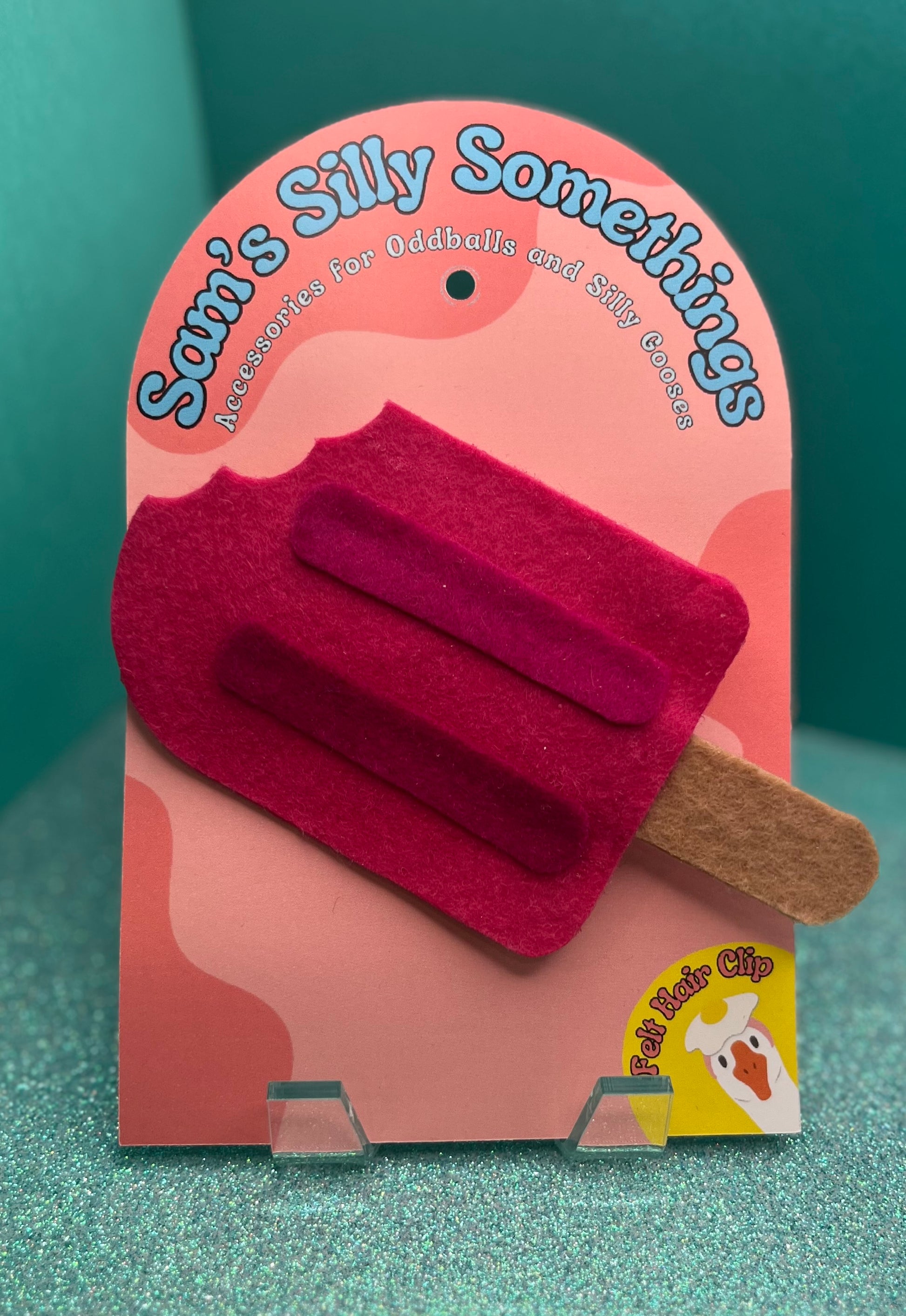 Pink ice cream popsicle-shaped hair clip on a pink packaging with 'Sam's Silly Somethings' branding.